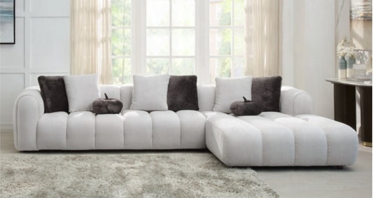 Channel tufted Right facing sectional upholstered in white fabric waccent pillows